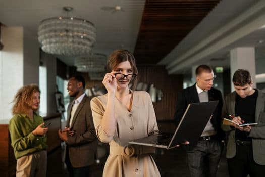 A group of professionals in a stylish office setting, engaged in a business meeting.