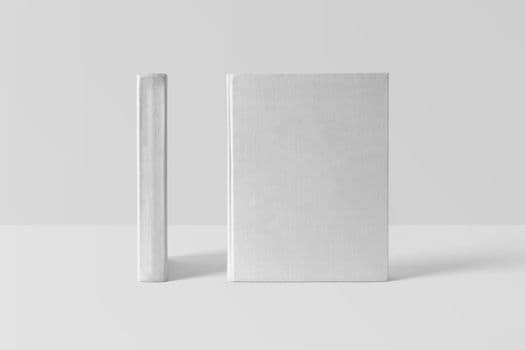 Two blank book covers on a white surface, ideal for mockup and design projects.