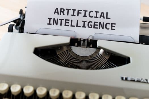 A close-up of a typewriter showcasing 'ARTIFICIAL INTELLIGENCE' on paper.